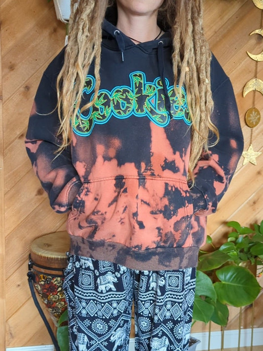 A young girl wearing a bleach dyed hoodie and sporting dreadlocks, exuding a unique style and individuality